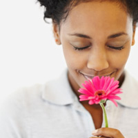 Woman smelling flower