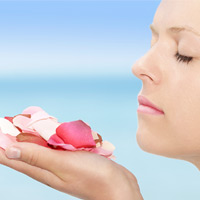 Woman smelling flower petals
