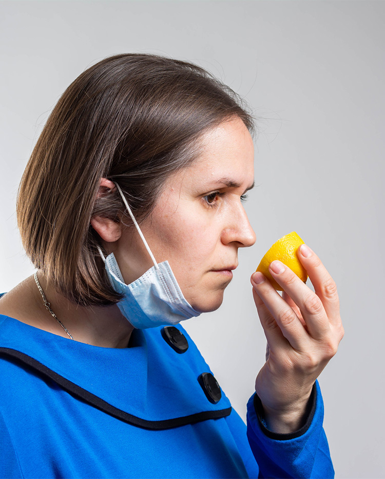 Woman smelling a lemon
