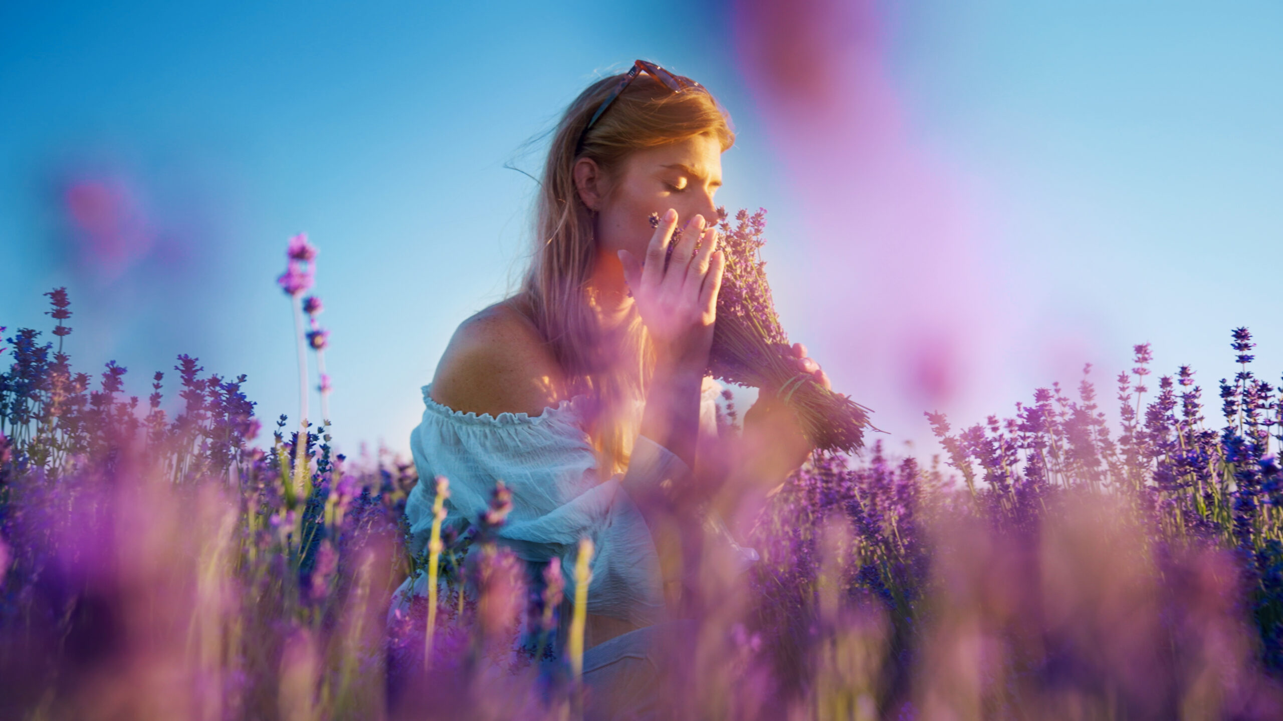 Woman making lavender bouquet. Picking fresh flowers and enjoying the smell
